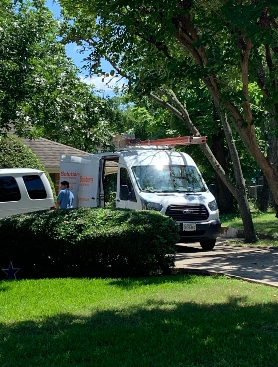 Shaded residential neighborhood street with trees and lawn