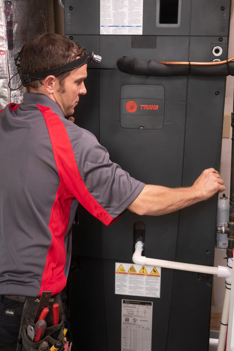 HVAC technician working inside a mechanical area
