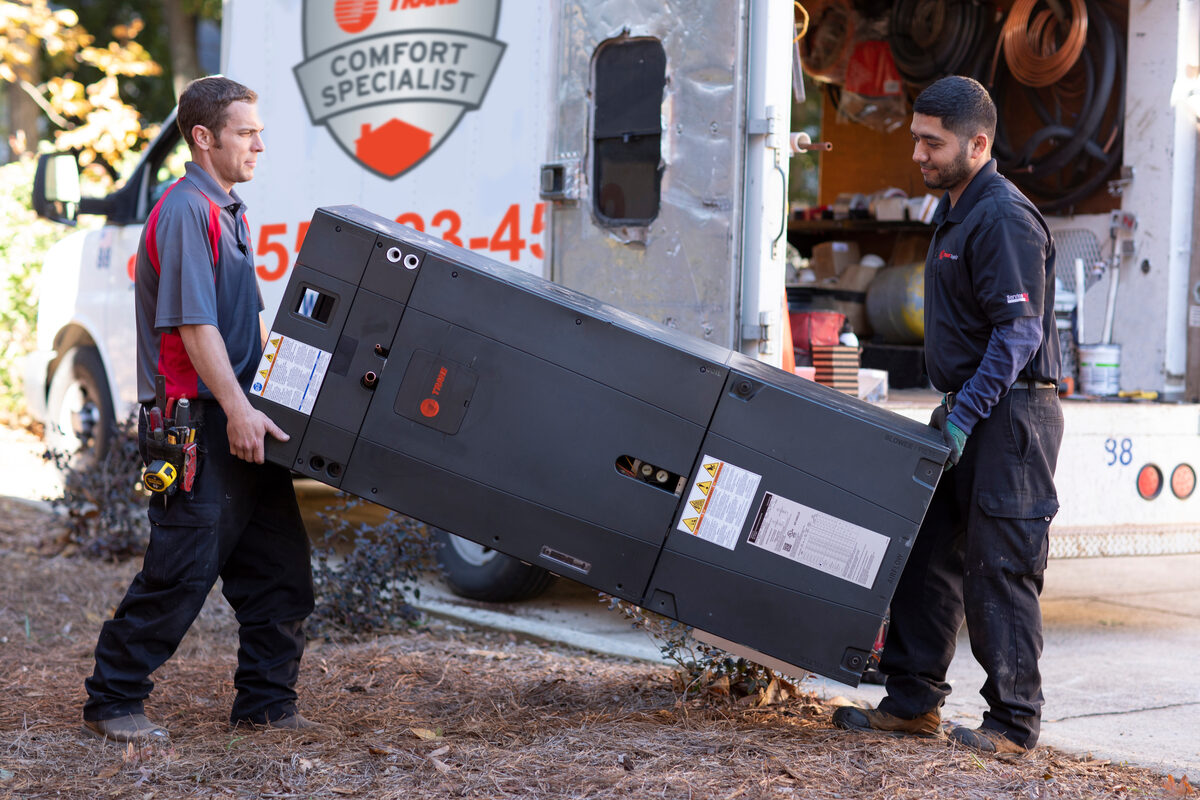 Technician unloading equipment from a service truck
